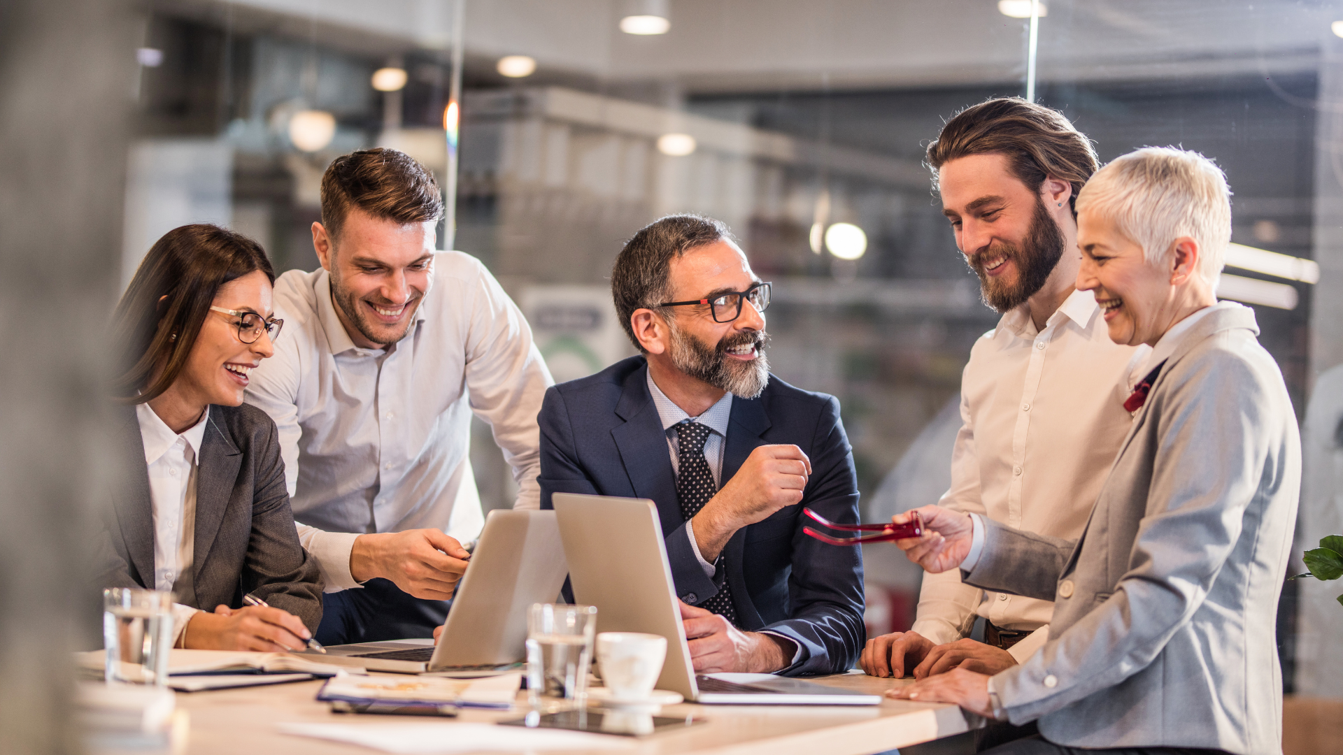 Business team around a table with laptop having a discussion