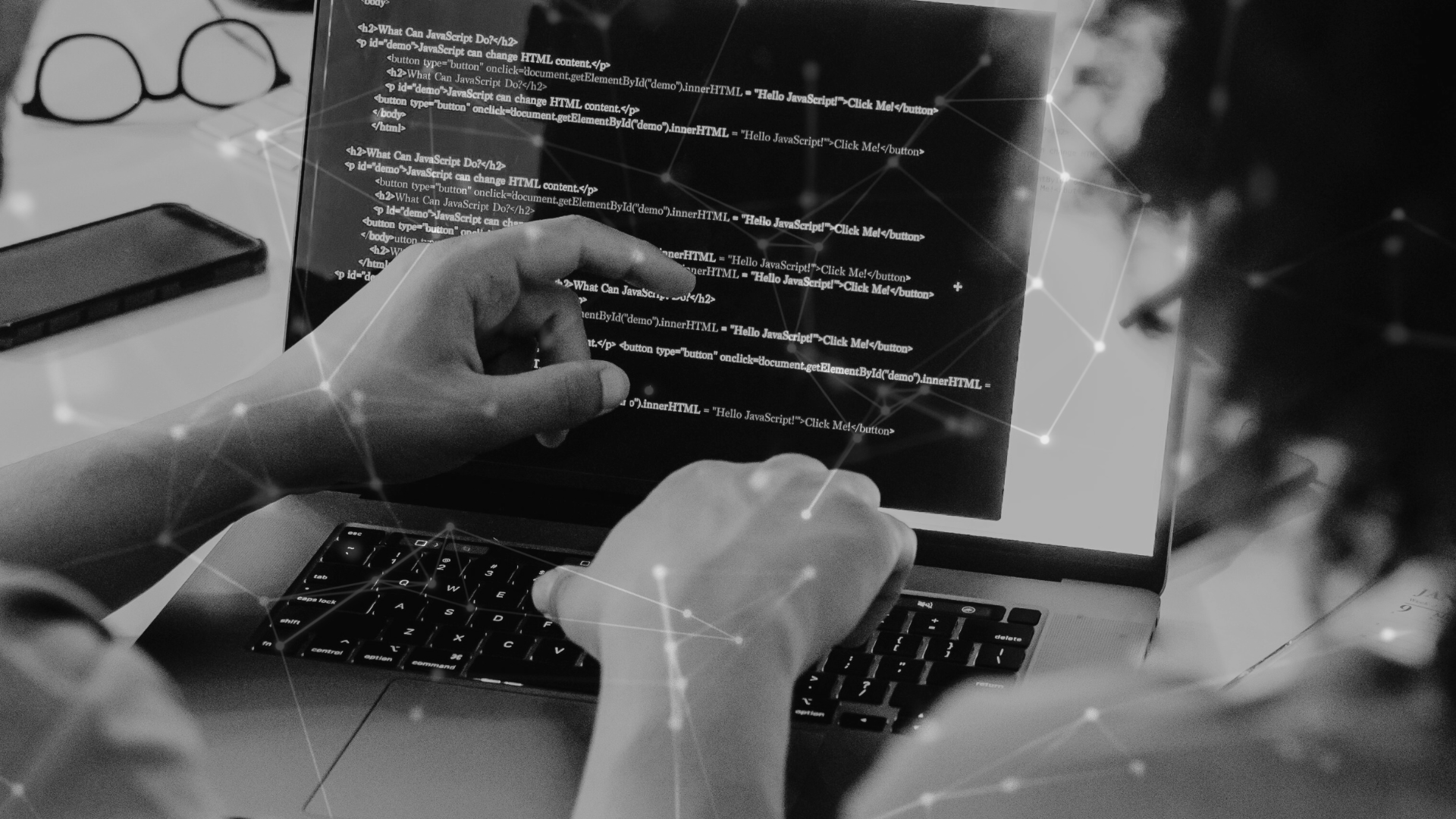 code on a laptop with people working on it